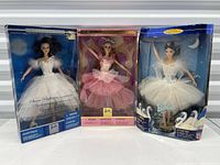 Front view showing all three boxed Barbie dolls