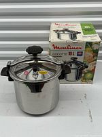 Pressure cooker with lid beside original box