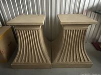 Pair of matching plaster pedestals side by side