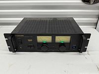 Front view of Pyramid PA-310 amplifier showing VU meters, controls, rack ears, missing meter range cap