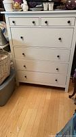 Front view of white six-drawer dresser