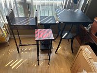 Four plant stands grouped together