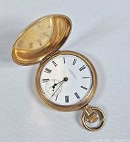 Open hunter case showing dial, bow, crown