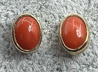 Front view showing coral cabochons and gold setting