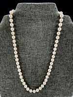 Full view of pearl necklace on display bust