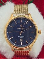 Front view showing blue dial, Maserati logo, date window, gold markers