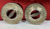 Front view of both sterling silver round brooches