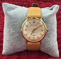 Front view of Smiths Astral wristwatch on pillow showing dial, case, and strap