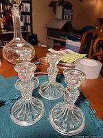 All four pressed glass candlesticks on table