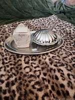 All three items on tray: ceramic box, shell dish, tray visible