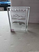 Front view of crystal paperweight showing etched Alaska scene