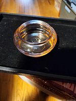 side view of amber-orange depression glass bowl