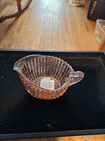 side view showing ribbed walls, handle, spout