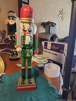 Front view of glittery nutcracker with sword