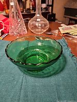 Top view of green glass bowl showing scalloped edge and interior ribbing