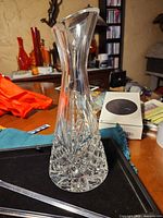 Front view of leaded crystal vase and stir rods on tray