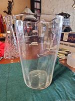 Front view showing full shape of clear glass vase on table