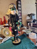 Front view of shopper nutcracker with presents and accessories