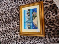 Framed 3D relief plaque showing Statue of Liberty and skyline in gold frame on patterned background