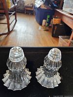 Front view of both shakers standing upright showing overall form and tops