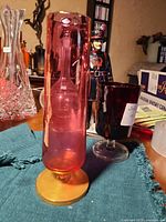 Full view of rose glass vase on metal base