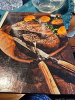 Front cover showing steak and carving set