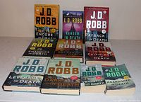 Full group of ten J.D. Robb novels arranged in rows
