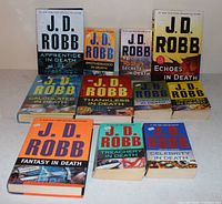 Front view of eleven J.D. Robb “In Death” novels showing covers and format mix