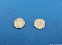 Reverse sides showing 25 CENTS CANADA 1916 & 1917 within wreath