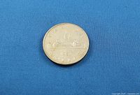 Reverse side showing Voyageur canoe design and 1951 date