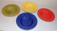 Top view of four colored pasta bowls