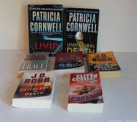 Front covers of seven paperback novels arranged in two rows