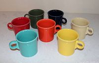 Seven Fiesta mugs upright showing exterior colors