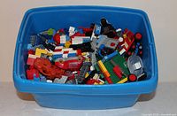 Overall view of blue bin filled with assorted LEGO pieces