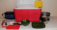 Overall shot showing cooler, cookware, tableware and accessories