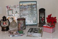 Full lot showing snow globes, puzzle, craft kits, tins, poinsettia
