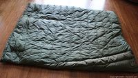Full view of folded green double sleeping bag