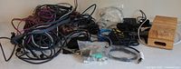 Wide view of mixed cables, adapters and wooden stand on table