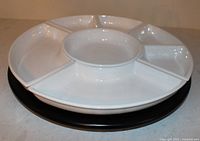 Side view of assembled 18-inch Lazy Susan with sectional dishes on black base