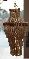 Overall view of seashell hanging planter showing tiered shape and hanging loop
