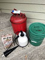 Group view of gas can, sprayer, bucket, red rock bag