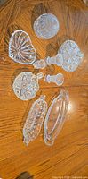 All 10 pressed glass pieces arranged on table