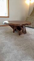 Full view of table showing burl top on driftwood base