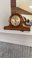 Full view of wood mantel clock on mantle