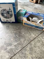 Three boxed lighting items on floor