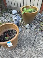 Overview showing both pots, boy statue, metal plant stand