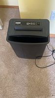 Full view of Fellowes paper shredder with power cord
