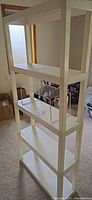 assembled white plastic shelving showing four tiers