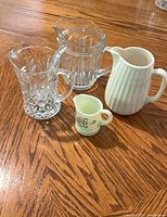 Group shot of four pitchers on wooden surface