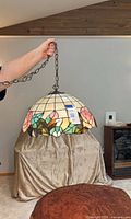 Full view of stained glass swag lamp with chain